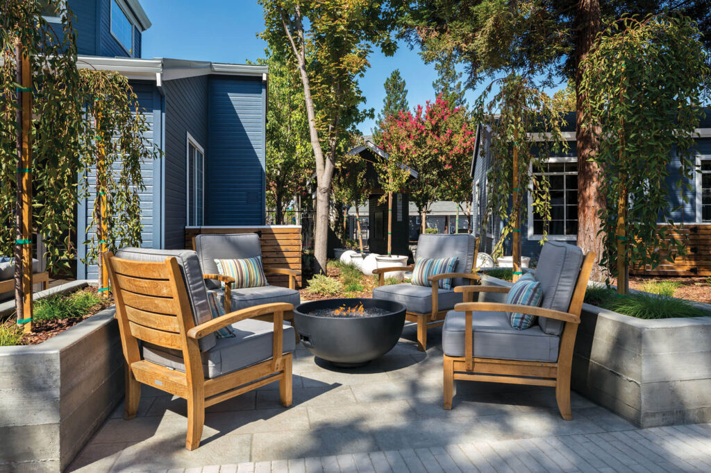Outdoor seating around a fire pit near leasing office