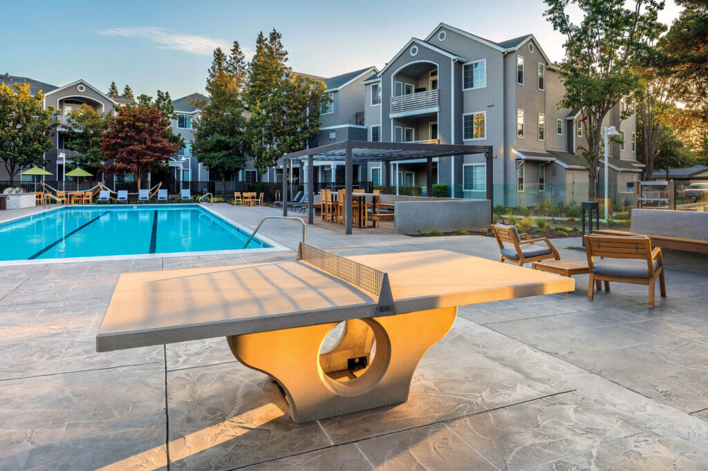 Outdoor ping pong table next to swimming pool